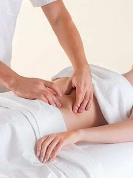 The picture of beautiful woman in massage salon and male hands on her body